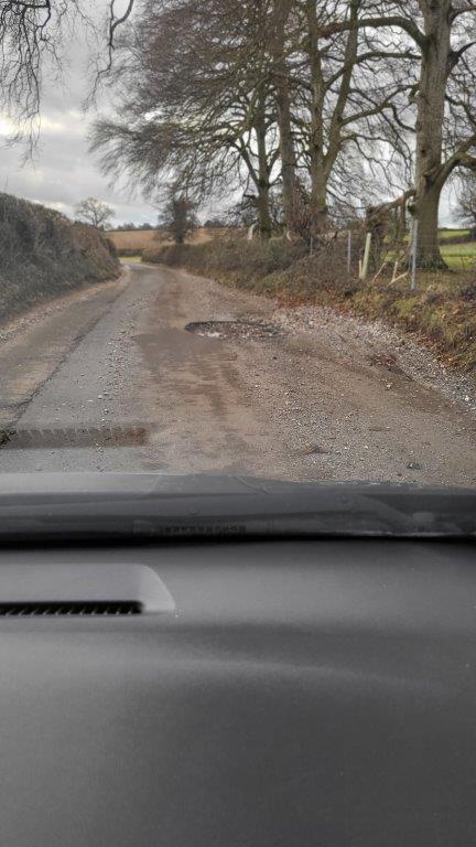 Road Damage near Garston Wood